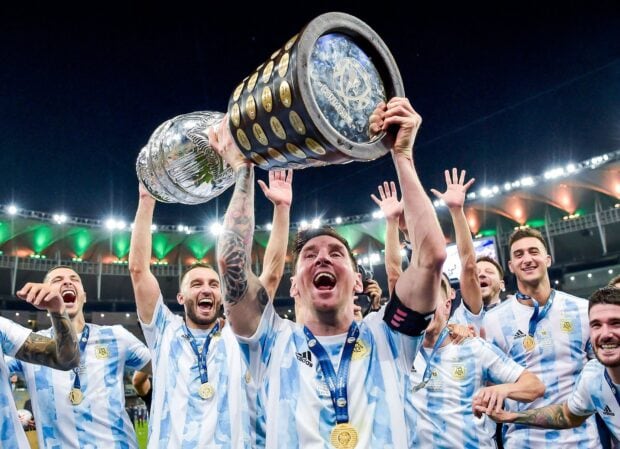 Argentina team celebrating with the trophy after winning the football tournament