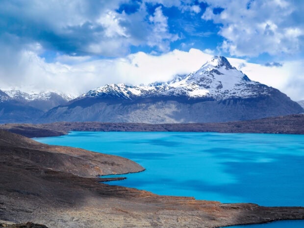 Snow capped mountains and turquoise lake in Argentina landscape
