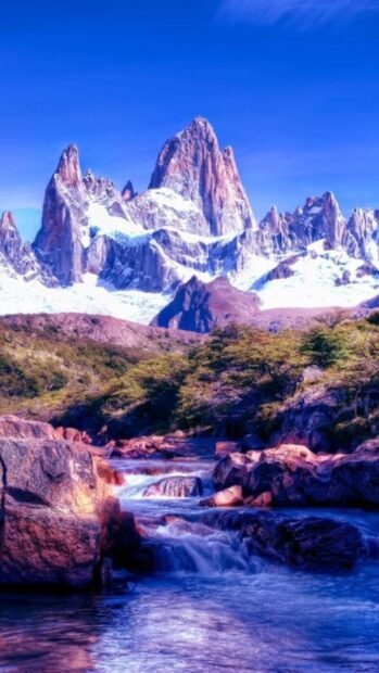 Snowy mountain peaks and flowing river in Argentina landscape