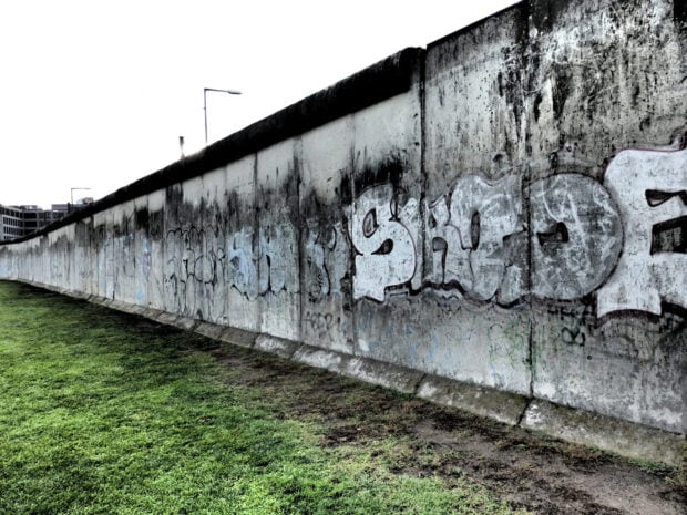 A section of the Berlin Wall covered with graffiti showing the historical Berlin Wall