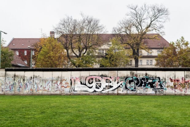 Graffiti art on the Berlin Wall showing peace signs and abstract designs
