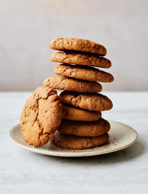 A stack of crunchy biscuit resting on a plate on a marble surface