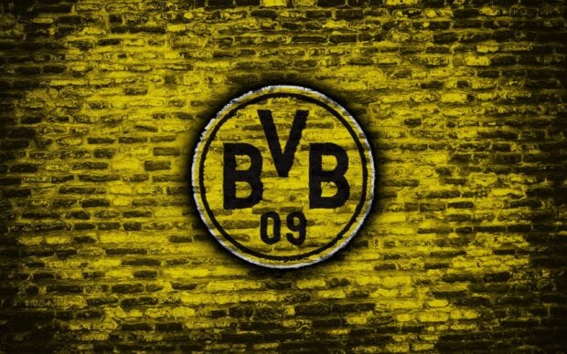 Borussia Dortmund logo painted on a yellow brick wall with BVB lettering and 09 number