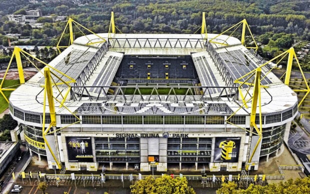 Aerial view of Borussia Dortmund stadium Signal Iduna Park surrounded by trees and urban area