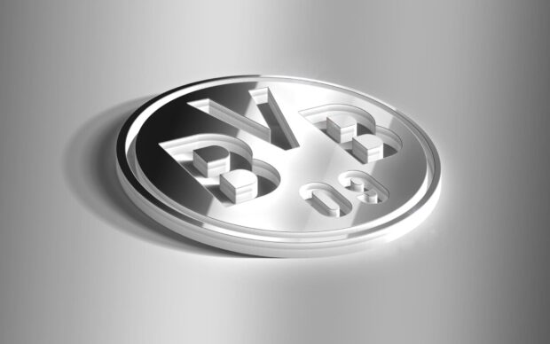 A silver 3D Borussia Dortmund logo on a reflective surface with a modern design