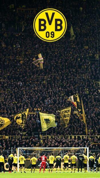 Borussia Dortmund players facing passionate Borussia Dortmund fans in the stadium