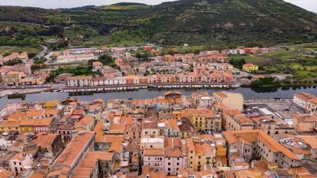 Aerial view of Bosa Italy town with colorful buildings and green hills