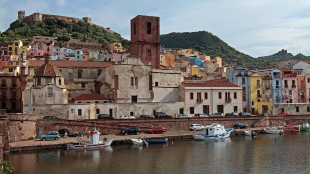 Historic townscape of Bosa Italy with colorful houses and boats on the river
