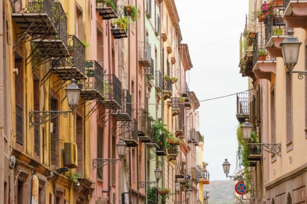 Colorful historic buildings with balconies and plants in Bosa Italy