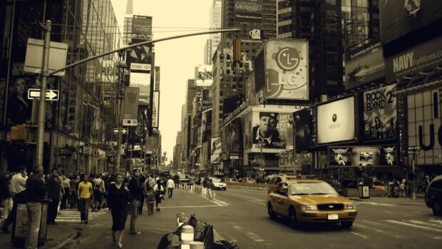 Sepia tone view of Broadway street with people and yellow taxi in the cityscape