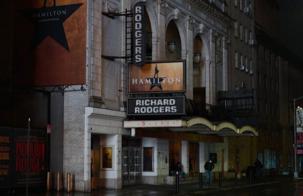 The Richard Rodgers theater marquee with Hamilton musical posters on a Broadway street at night