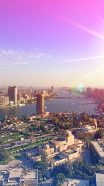 Aerial view of Cairo Egypt featuring the Nile River and urban landscape under a purple sky