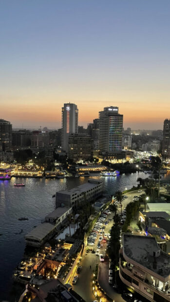 Sunset view of Cairo Egypt cityscape with Nile River and vibrant buildings at dusk