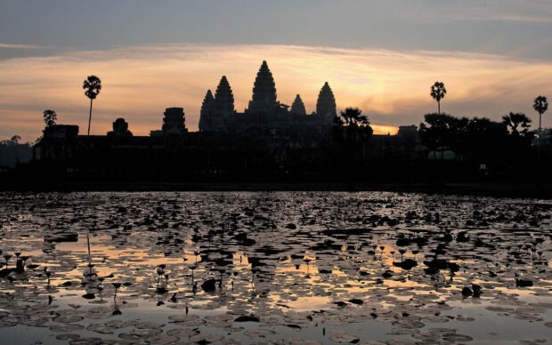 Ancient Cambodia temple silhouette with lotus pond at sunrise in Cambodia