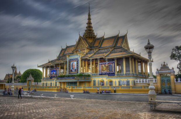 Traditional Cambodia architecture with pagoda and portraits in an urban setting