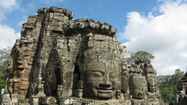 Ancient stone faces carved in Cambodia temple showing Cambodia culture