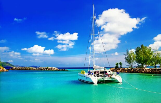 White catamaran on turquoise water in a peaceful tropical bay