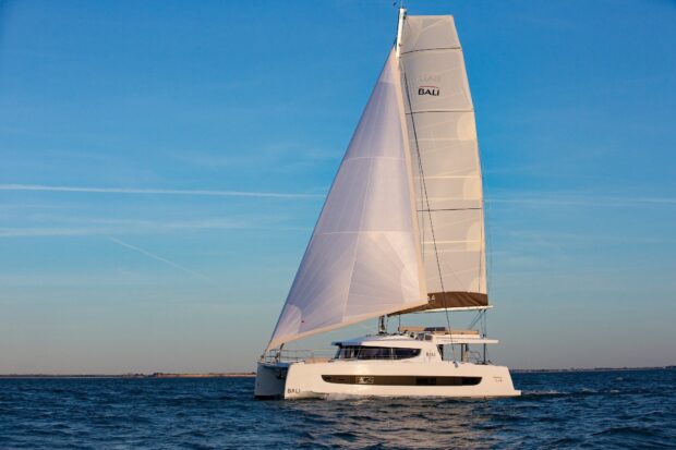 White catamaran sailing on the open sea during a clear sunny day