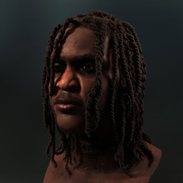 Close up of Chief Keef with twisted dreadlocks and tattoos on neck