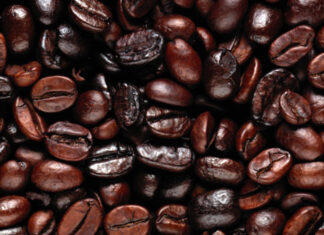 Close up of roasted coffee beans with different shades and textures
