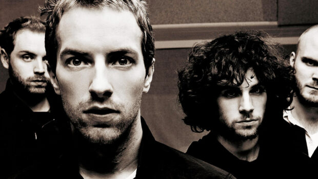 Close up of Coldplay band members posing in a black and white photo