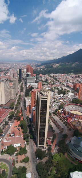 Aerial view of Colombia cityscape with tall buildings and mountains in the background