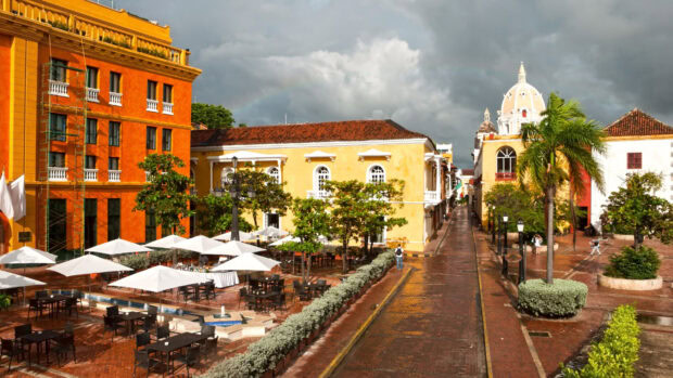 Historic colonial buildings and outdoor seating in Colombia cityscape