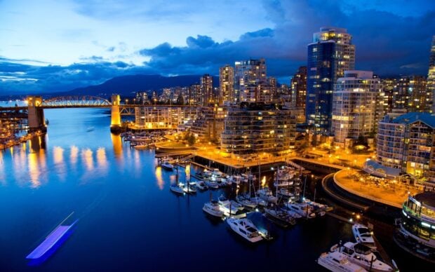 Night view of Colombia city harbor with illuminated buildings and boats in harbor