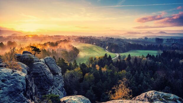 Rocky cliffs and green forests with autumn colors in Colombia landscape at sunrise