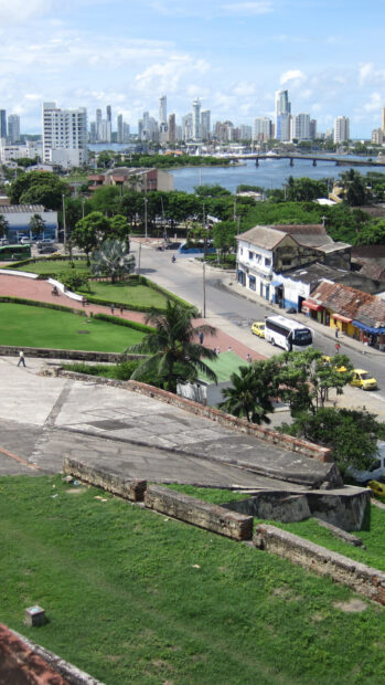 Historic city park with stone pathways and modern buildings in Colombia skyline
