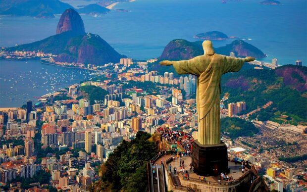 The Corcovado Mountain overlooks the cityscape of Rio de Janeiro with the iconic statue of Christ the Redeemer