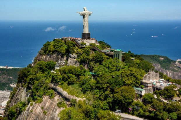 A scenic view of Corcovado Mountain with the Christ the Redeemer statue overlooking the coast