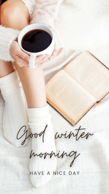 Person wearing socks holding coffee on a winter morning with an open book and good winter morning text