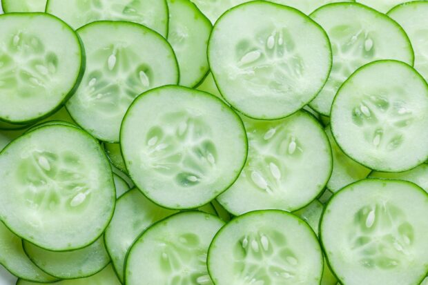 Fresh cucumber slices showing the natural texture and seeds of cucumber