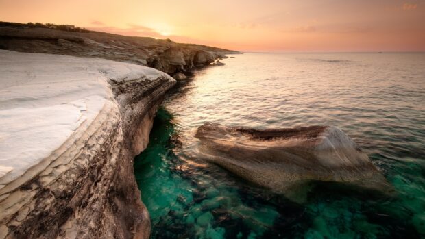 Natural rock formations at the Cyprus coastline during sunset