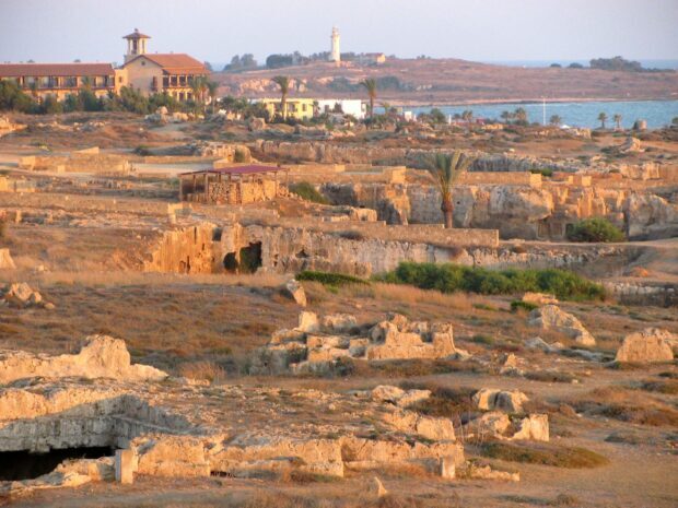 Ancient Cyprus ruins with historical structures and coastline in the background