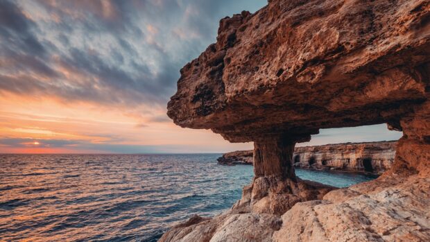 Natural rock formations beside the sea at sunset in Cyprus coast