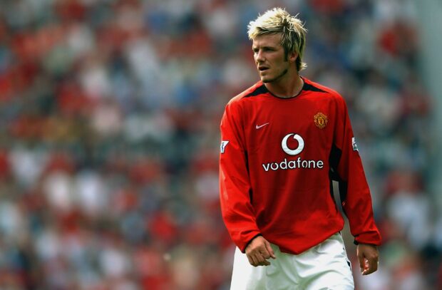 David Beckham wearing a red Manchester United jersey on the football field
