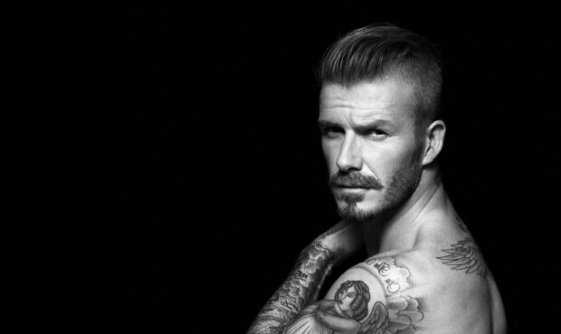 David Beckham with tattoos posing in black and white portrait