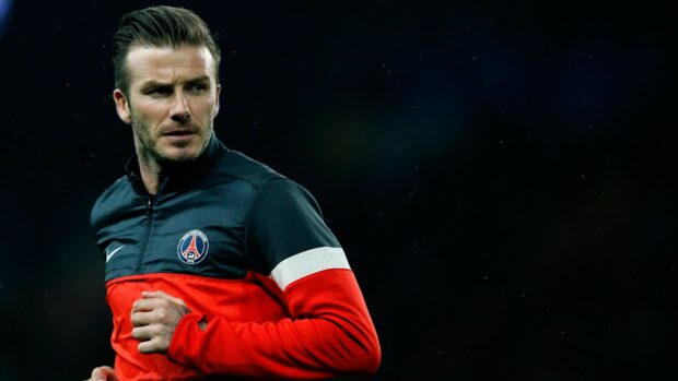 David Beckham wearing a Paris Saint Germain jacket during a football match