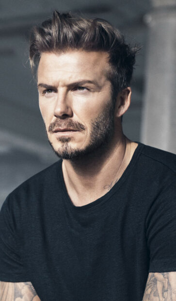 David Beckham with a serious expression and styled hair looking into the distance