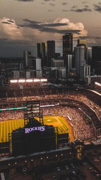 Evening view of Denver skyline and Rockies baseball stadium during game