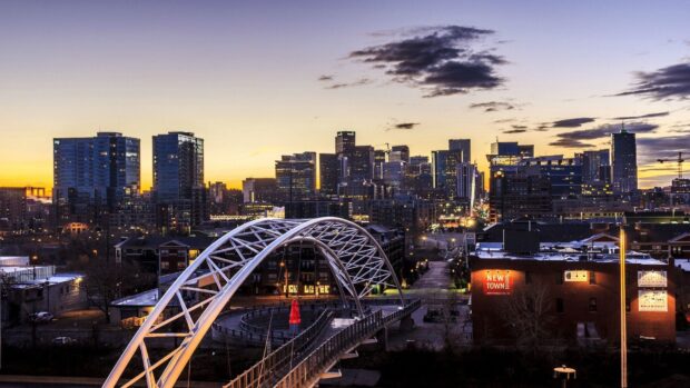 Denver city skyline with bridge and buildings during sunset in Colorado