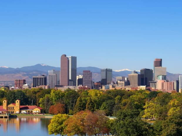 Denver skyline with colorful trees and mountains in Denver Colorado