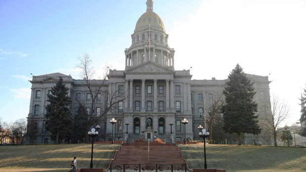 Historic Denver Colorado building with steps and trees on a clear day
