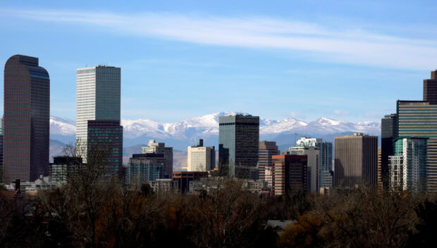 Denver skyline view with snow capped mountains in the background on a clear day