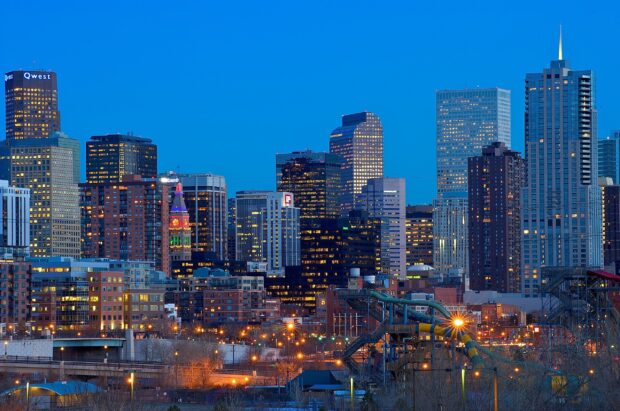 Denver skyline at dusk with illuminated buildings and clear blue sky in 2K quality