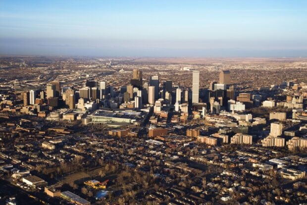 Aerial view of Denver skyline with urban landscape and clear sky in downtown area