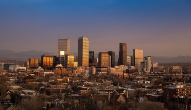 Denver skyline with golden reflections at sunset showcasing urban architecture