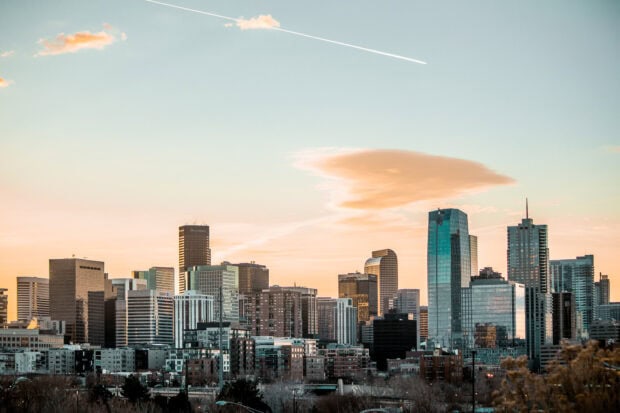 Denver skyline with modern buildings under a soft sunset sky in high definition